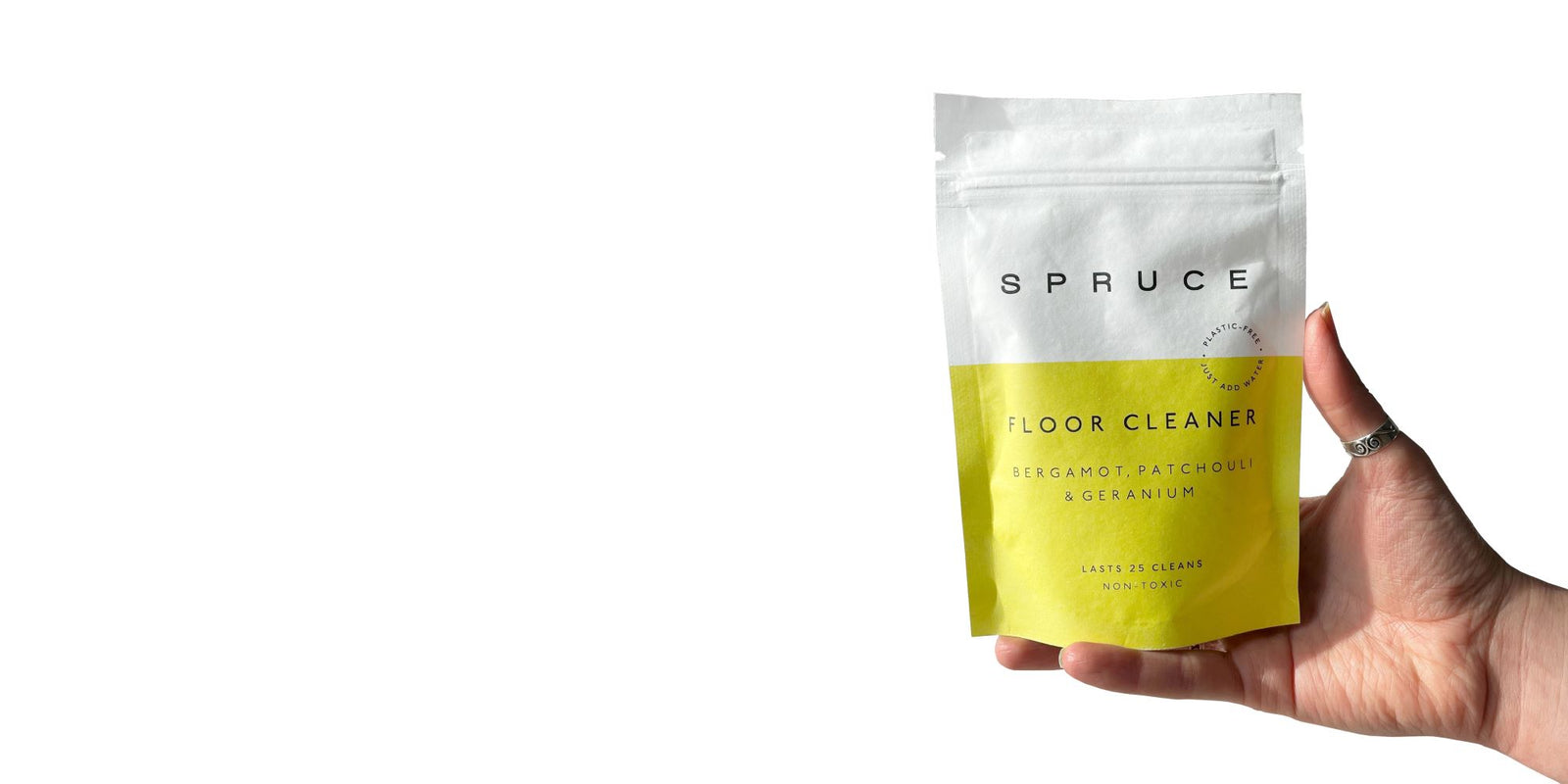 hand holding eco floor cleaner with compostable packaging