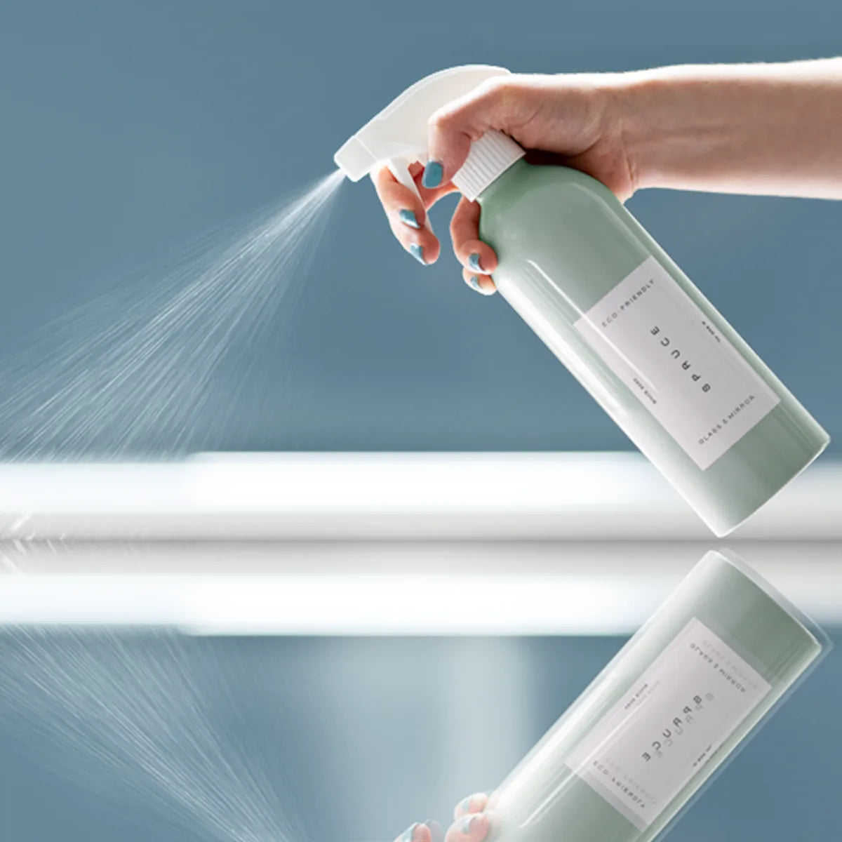 glass and mirror cleaner spraying onto a glass surface